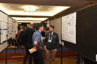 People talking in front of their posters